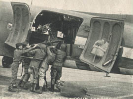 [53rd Troop Carrier Wing: loading .50 caliber machine gun]